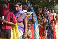 A child stands with adults waiting in a queue to cast their votes outside a polling station at Paliganj, in the eastern Indian state of Bihar, Wednesday, Oct. 28, 2020. Voting began Wednesday in India’s third-largest state of Bihar, the first major election in the country since the pandemic and a test for Prime Minister Narendra Modi’s popularity as he faces criticism on many fronts. (AP Photo/Aftab Alam Siddiqui)