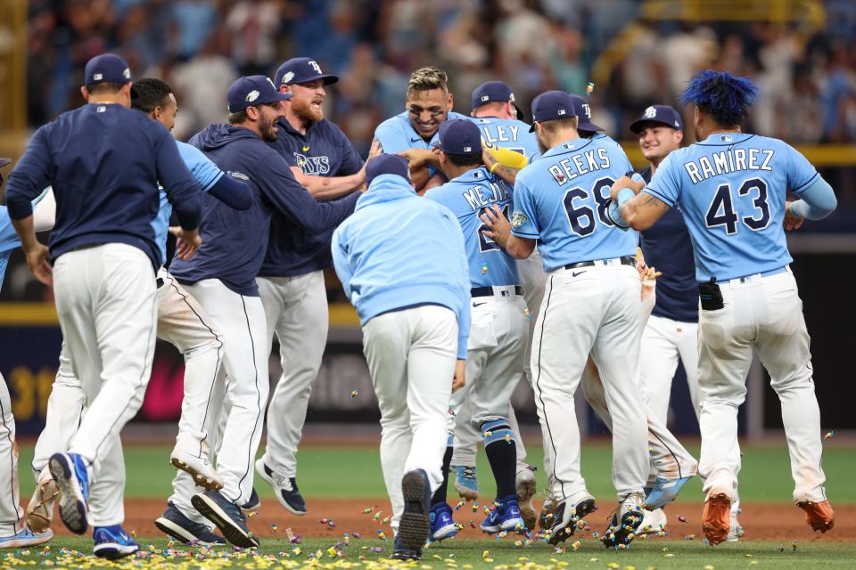 Rays players celebrate a walk-off win against the Yankees on Sunday.