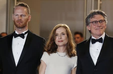 (L-R) Director Joachim Trier, cast members Isabelle Huppert and Gabriel Byrne pose on the red carpet as they arrive for the screening of the film "Louder Than Bomb" (Plus fort que les bombes) in competition at the 68th Cannes Film Festival in Cannes, southern France, May 18, 2015. REUTERS/Regis Duvignau