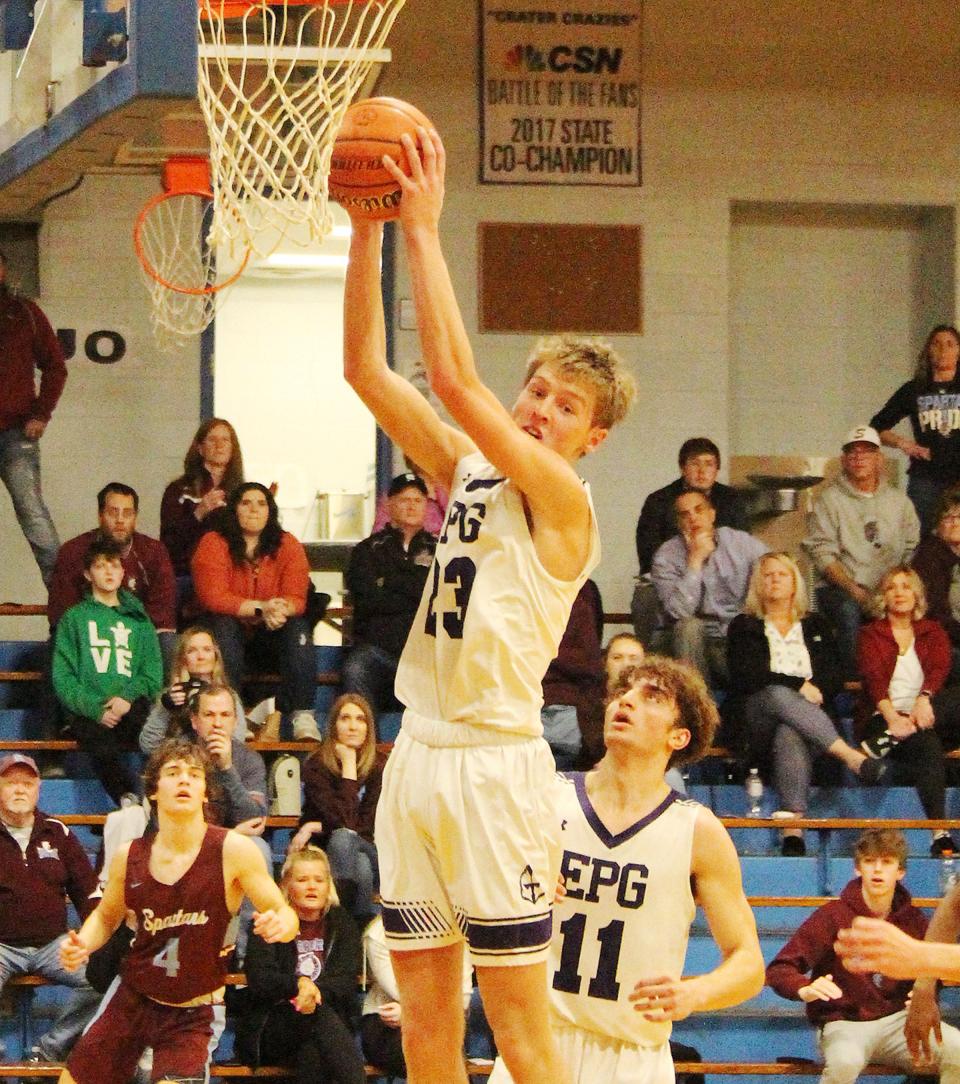 El Paso-Gridley's Jake Funk snares a rebound Wednesday against St. Joseph-Ogden. Funk had 12 points and 11 boards in the Titans' win.