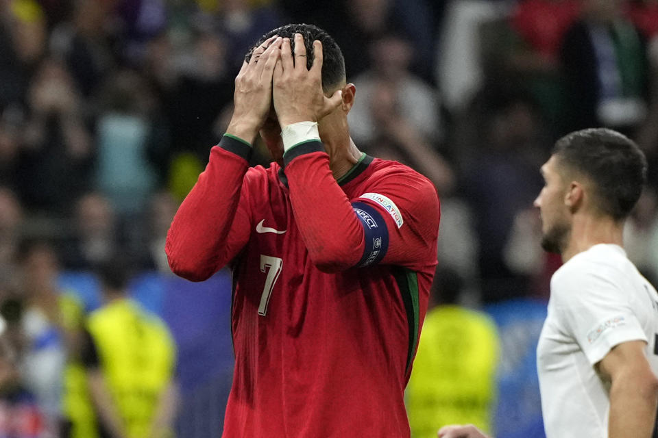 Portugal's Cristiano Ronaldo reacts after he failed scoring a penalty during a round of sixteen match between Portugal and Slovenia at the Euro 2024 soccer tournament in Frankfurt, Germany, Monday, July 1, 2024. (AP Photo/Matthias Schrader)