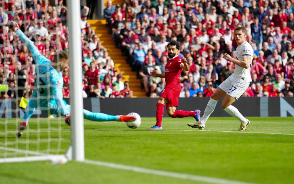 Tottenham's goalkeeper Guglielmo Vicario, left, blocks a shot on goal by Liverpool's Mohamed Salah