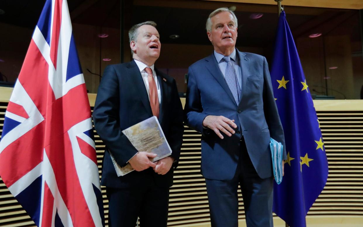 EU chief negotiator Michel Barnier, right, speaks with Britain's chief negotiator David Frost