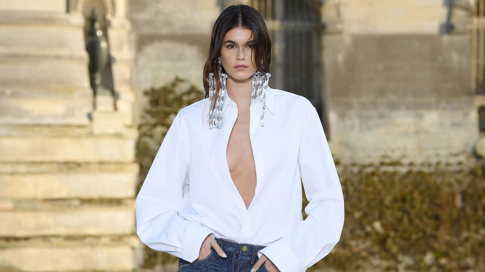 Kaia Gerber opened Valentino in a pair of trompe l'oeil jeans hand-embroidered with blue pearls. - Courtesy Valentino