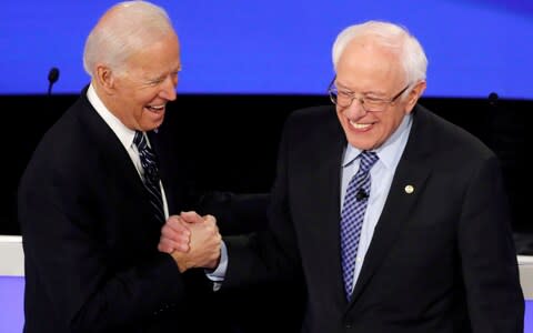 Democratic 2020 U.S. presidential candidates former Vice President Joe Biden greeets Senator Bernie Sanders as they take the stage for the seventh Democratic 2020 presidential debate at Drake University in Des Moines - Credit: Reuters