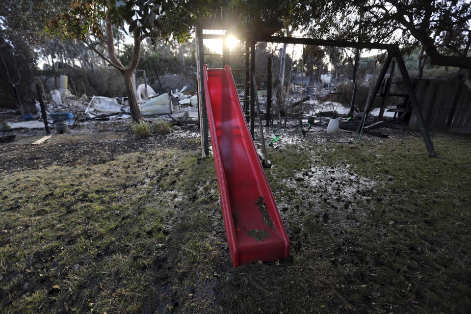 A child's slide and swingset stand behind a home destroyed by the Woolsey fire on Dume Drive in the Point Dume area of Malibu in Southern California, Tuesday, Nov. 13. (Photo: ASSOCIATED PRESS)