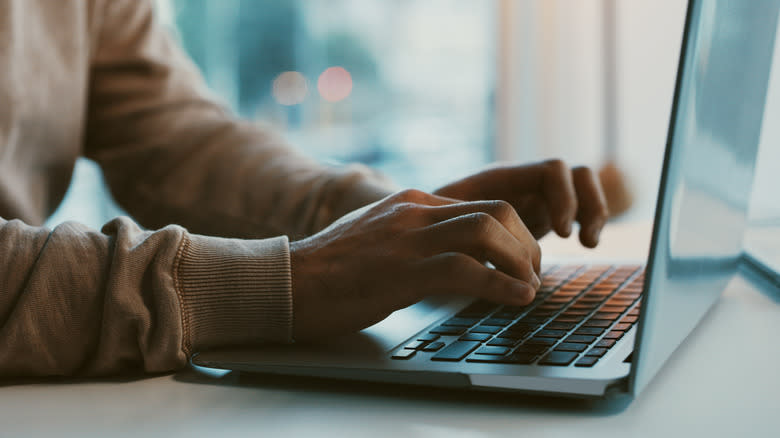 person typing on laptop