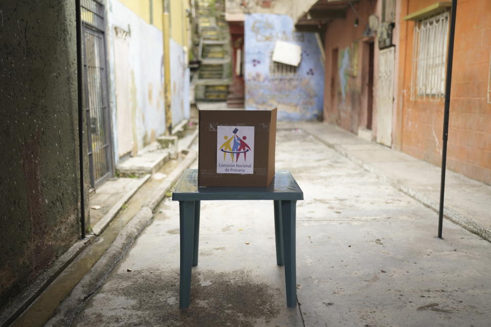 A ballot box sits on a street in a residential area of Petare during the opposition presidential primary election in Caracas, Venezuela, Sunday, Oct. 22, 2023. The opposition will pick one candidate to challenge President Nicolás Maduro in 2024 presidential elections. (AP Photo/Ariana Cubillos)