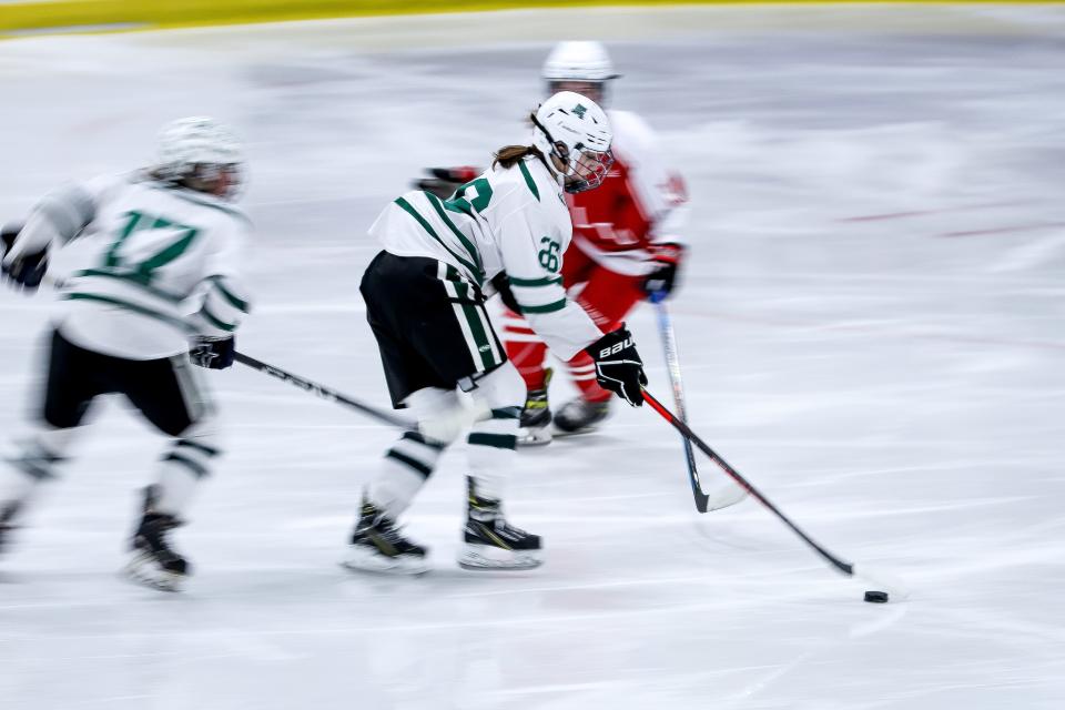 Canton's Izzy Cusack handles the puck as a blur of motion during the Sweet 16 game against Milton in the Div. 2 state tournament at Canton Ice House on Saturday, March 4, 2023.