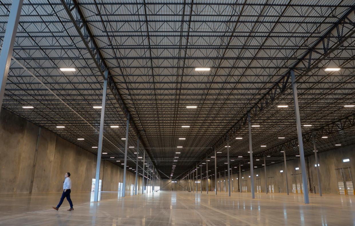 People look at the inside a new warehouse at 9500 W Reno Ave. during a broker's open house hosted by Chris Roberts with Price Edwards & Co.