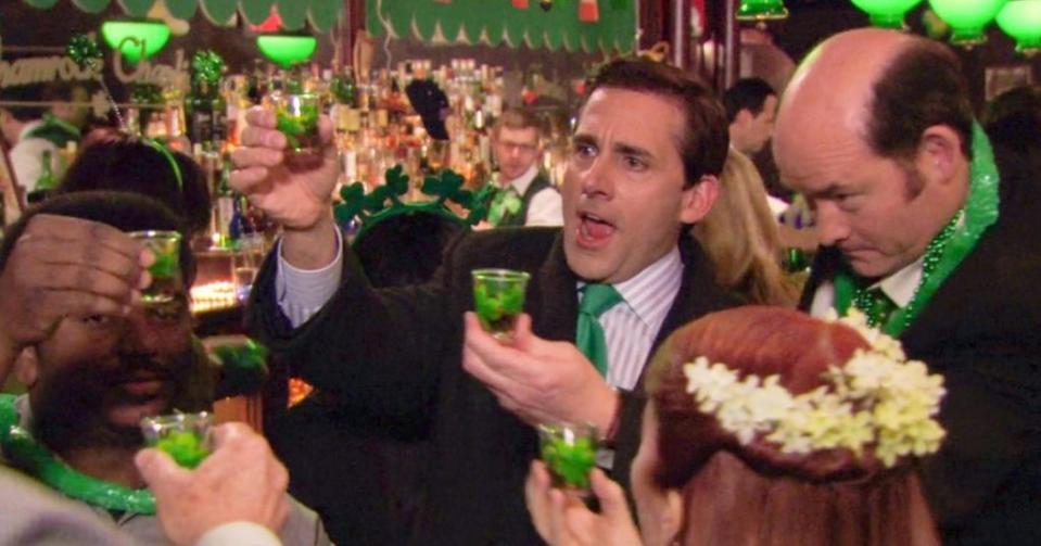 Dunder Mifflin’s Michael Scott (Steve Carell, left) joins his staff for festivities after a long day in the office. NBC
