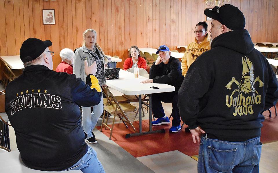 Kevin Palmer and David Cyr of the Liberal Club Holy Ghost Feast board of directors speak with Veteran's Kitchen volunteers at the Liberal Club function hall in Fall River.