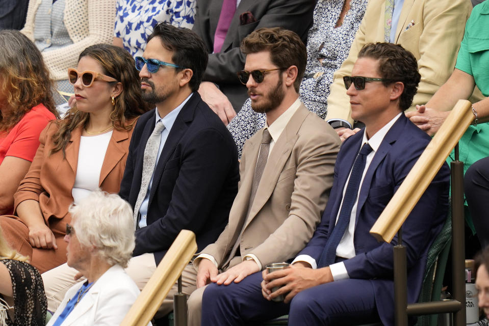 Actor Andrew Garfield, second right, and Lin-Manuel Miranda, second left, sit in the Royal Box ahead of the final of the women's singles between the Czech Republic's Marketa Vondrousova and Tunisia's Ons Jabeur on day thirteen of the Wimbledon tennis championships in London, Saturday, July 15, 2023. (AP Photo/Kirsty Wigglesworth)