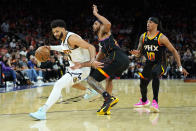 Denver Nuggets guard Jamal Murray (27) drives around Phoenix Suns guard Cameron Payne during the second half of Game 6 of an NBA basketball Western Conference semifinal series, Thursday, May 11, 2023, in Phoenix. The Nuggets eliminated the Sun in their 125-100 win. (AP Photo/Matt York)