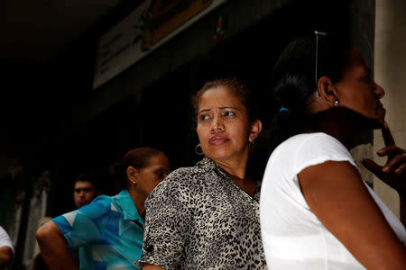 People queue on the street as they try to buy food outside a supermarket in Caracas, Venezuela May 23, 2016. REUTERS/Carlos Garcia Rawlins