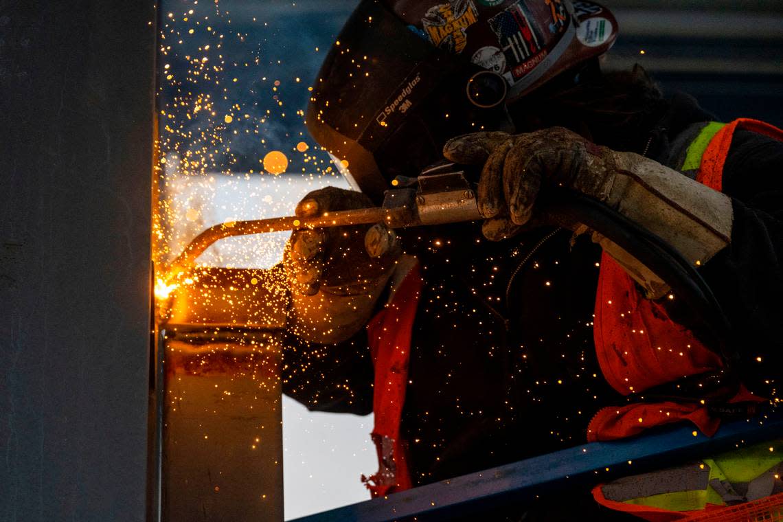 Welder Sean Mahoney, from Apex Local 86, works on a joint as contractors for Sound Transit work on the new Kent/Des Moines station on the Federal Way Link extension project on Wednesday, Dec. 28, 2022. It’s one of three new stations on the 7.8-mile route. The station is located between Interstate 5 and Pacific Ave., adjacent to Highline College in Des Moines. The $2.54 billion project is projected to begin operating in 2025.