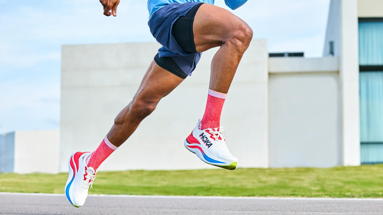  The bottom half of a male running in the Hoka Skyward X running shoe. 