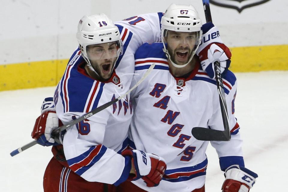 New York Rangers' Derick Brassard (16) celebrates his goal with Benoit Pouliot (67) in the first period of Game 5 of a second-round NHL playoff hockey series against the Pittsburgh Penguins in Pittsburgh, Friday, May 9, 2014. (AP Photo/Gene J. Puskar)