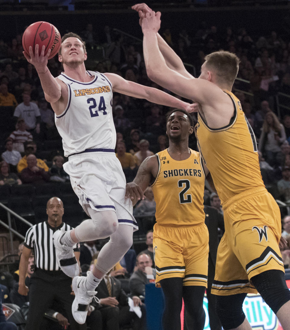 Lipscomb guard Garrison Mathews (24) goes to the basket against Wichita State guard Jamarius Burton (2) and guard Erik Stevenson (10) during the first half of a semifinal college basketball game in the National Invitational Tournament, Tuesday, April 2, 2019, at Madison Square Garden in New York. (AP Photo/Mary Altaffer)