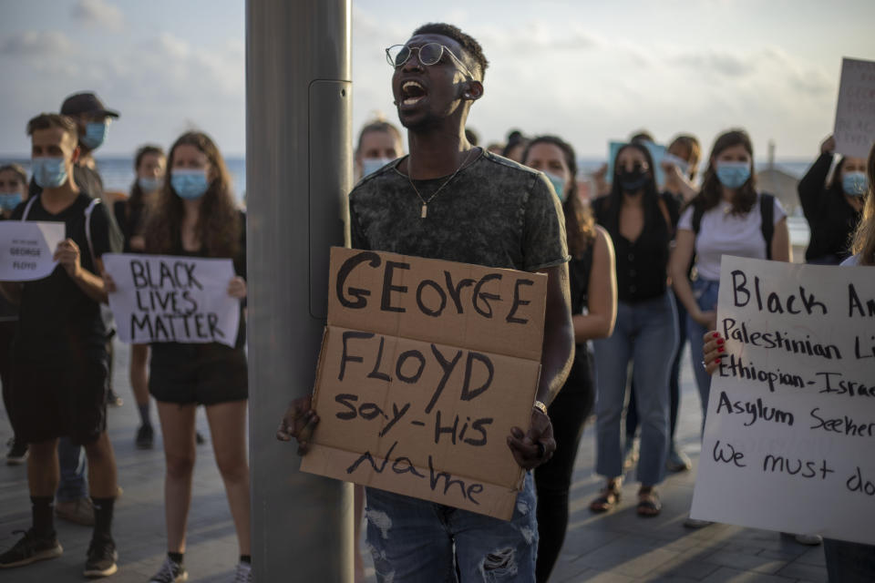 CLARIFIES THAT LOCATION IS THE U.S. EMBASSY BRANCH OFFICE TEL AVIV: Protesters shout slogans during a protest to decry the killing of George Floyd in front of the U.S. Embassy Branch Office, in Tel Aviv, Israel, Tuesday, June 2, 2020. (AP Photo/Ariel Schalit)