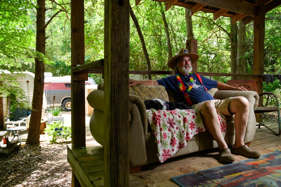 Glynn Zeigler, better known as his 'skunk name' Zig, sits on the porch of the Nap Shack where musicians and festival workers can go to have a peaceful moment during the Spring Skunk Festival on the Skunk Farm in Greer, S.C., on Saturday, May 13, 2023.