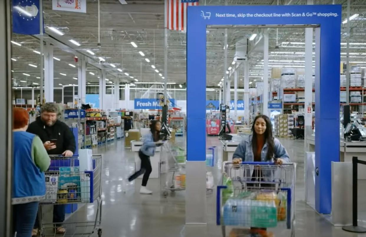 A person passes through new shopping cart scanning tech at Sam's Club.