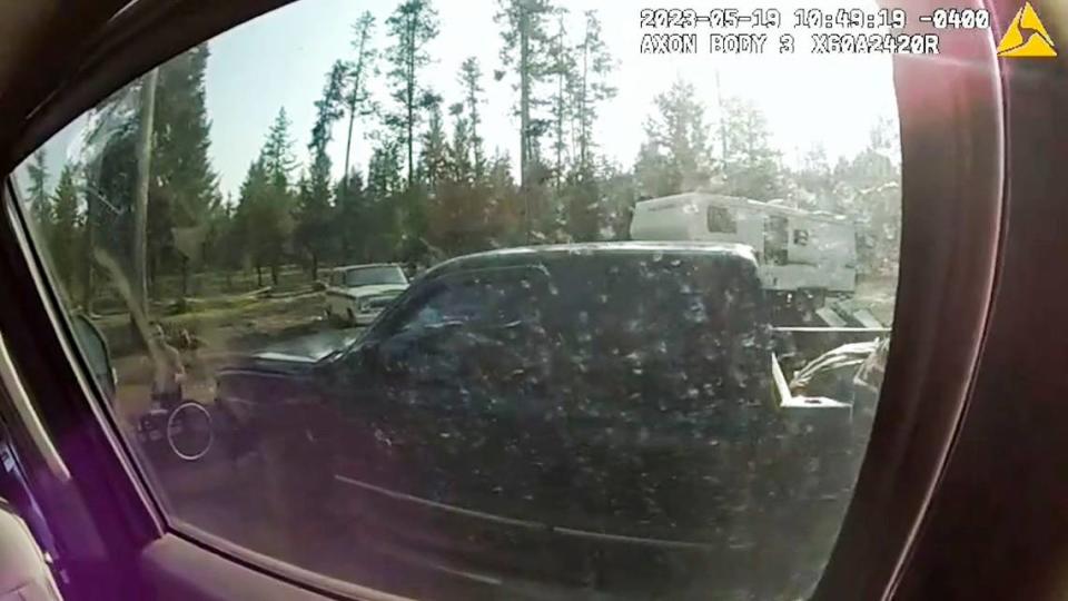 Through the window of federal agents’ vehicle, Brook Roberts can be seen holding a gun. U.S. Forest Service