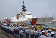 Philippine Coast Guard personnel salute to welcome the U.S. Coast Guard National Security Cutter Bertholf (WMSL 750) as it arrives for a port call in the first visit by a U.S. cutter in over seven years, Wednesday, May 15, 2019 in Manila, Philippines. Capt. John Driscoll, commanding officer of the Bertholf, told reporters that two Chinese Coast Guard ships were spotted off the South China Sea while they were conducting a joint exercise with Philippine Coast Guard. (AP Photo/Bullit Marquez)