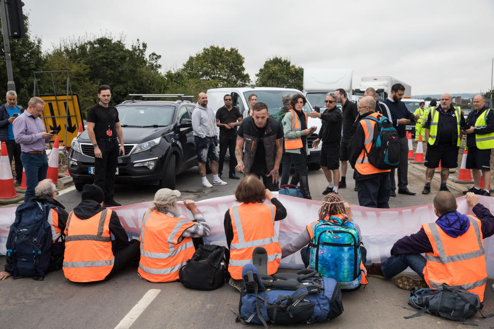 Insulate Britain climate activists block a slip road from the M25 at Junction 25 as part of a campaign intended to push the UK government to make significant legislative change to start lowering emissions on 15th September 2021 in Enfield, United Kingdom. The activists, who wrote to Prime Minister Boris Johnson on 13th August, are demanding that the government immediately promises both to fully fund and ensure the insulation of all social housing in Britain by 2025 and to produce within four months a legally binding national plan to fully fund and ensure the full low-energy and low-carbon whole-house retrofit, with no externalised costs, of all homes in Britain by 2030 as part of a just transition to full decarbonisation of all parts of society and the economy. (photo by Mark Kerrison/In Pictures via Getty Images)