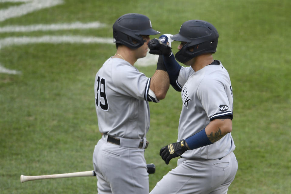 New York Yankees' Gary Sanchez, right, celebrates his home run with Mike Tauchman (39) during the second inning of the first baseball game of a doubleheader against the Baltimore Orioles, Friday, Sept. 4, 2020, in Baltimore. (AP Photo/Nick Wass)