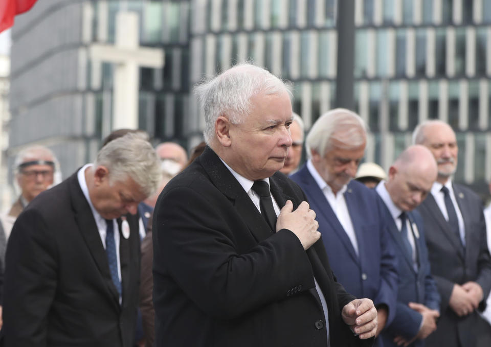 Poland's ruling party leader Jaroslaw Kaczynski, center, during a police-guarded ceremony in Warsaw, Poland, Friday, July 10, 2020 remembering his twin brother, the late president Lech Kaczynski and 95 others, killed in a plane crash in Russia in the year 2010. Friday was the last day of campaigning in Poland's presidential election runoff in which incumbent president, Andrzej Duda enjoys the right-wing ruling party's backing for a reelection, rivalling liberal Warsaw mayor, Rafal Trzaskowski. Opinion polls suggest the election may be decided by a small number of votes. (AP Photo/Czarek Sokolowski)