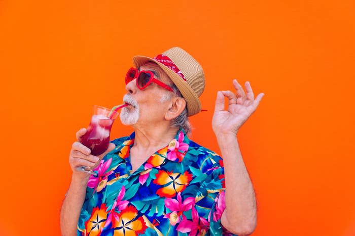 A man drinking a fruity cocktail