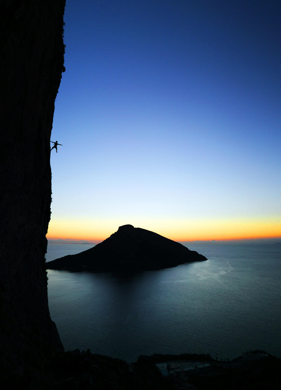 A climber poses on a rock during a climb in Kalymnos, Greece. (Photo: Adam Kokot/Caters News)