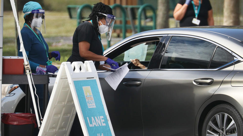 A healthcare worker with the Florida Department of Health in Broward prepares to administer a COVID-19 vaccine at a drive-thru vaccination site at Vista View Park on January 04, 2021 in Davie, Florida. (Joe Raedle/Getty Images)