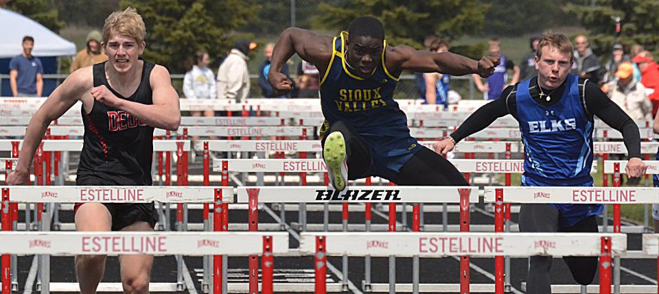 Deuel's Gabe Sather (left), Sioux Valley's Donovan Rose (center) and Elkton-Lake Benton's Blake DeVries head for the finish line in the boys' 110-meter hurdles during the Estelline Alumni Track and Field meet on Tuesday, April 23, 2024.