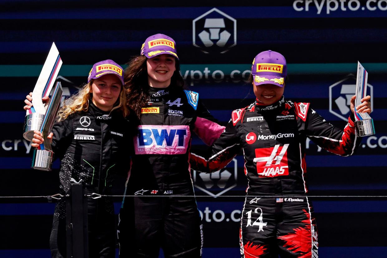 May 4, 2024; Miami Gardens, Florida, USA; F1 Academy driver Doriane Pin (28), F1 Academy driver Abbi Pulling (9) and F1 Academy driver Chloe Chambers (14) celebrate on the podium after the F1 Academy First Race at Miami International Autodrome. Pulling won first place, Pin won second place and Chambers won third place. Mandatory Credit: Peter Casey-USA TODAY Sports