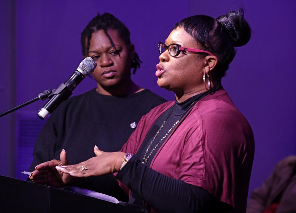 Vicki Lewis, mother of Isiah Lewis, addresses panel members as police and community leaders meet Sunday during a forum at Tower Theatre. At left is Adrianna Laws.