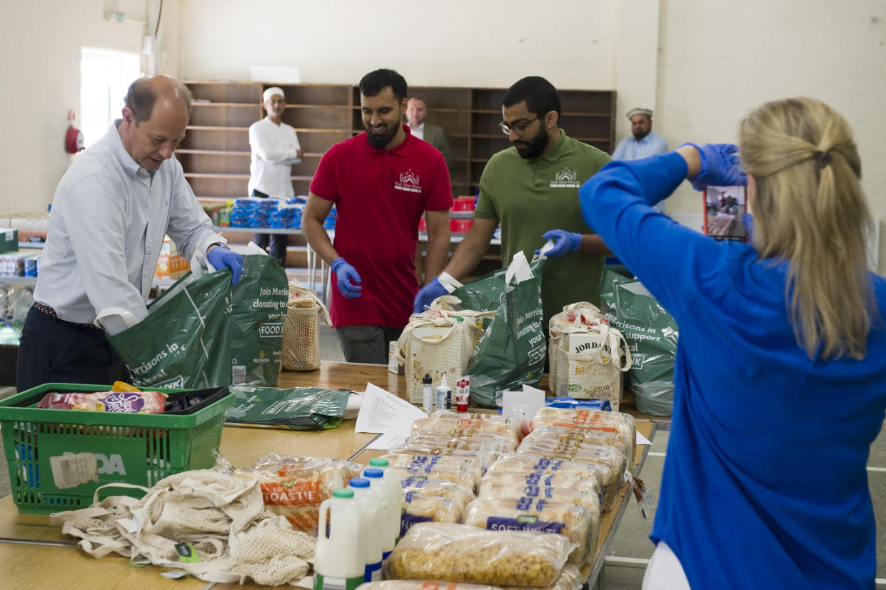 Embargoed to 1700 Thursday June 04 Undated handout photo issued by Steve Porter photography of Sophie, the Countess of Wessex taking a picture of Ali (centre), a fellow volunteer organising food deliveries at the Shah Jahan Mosque in Woking to NHS workers and others.