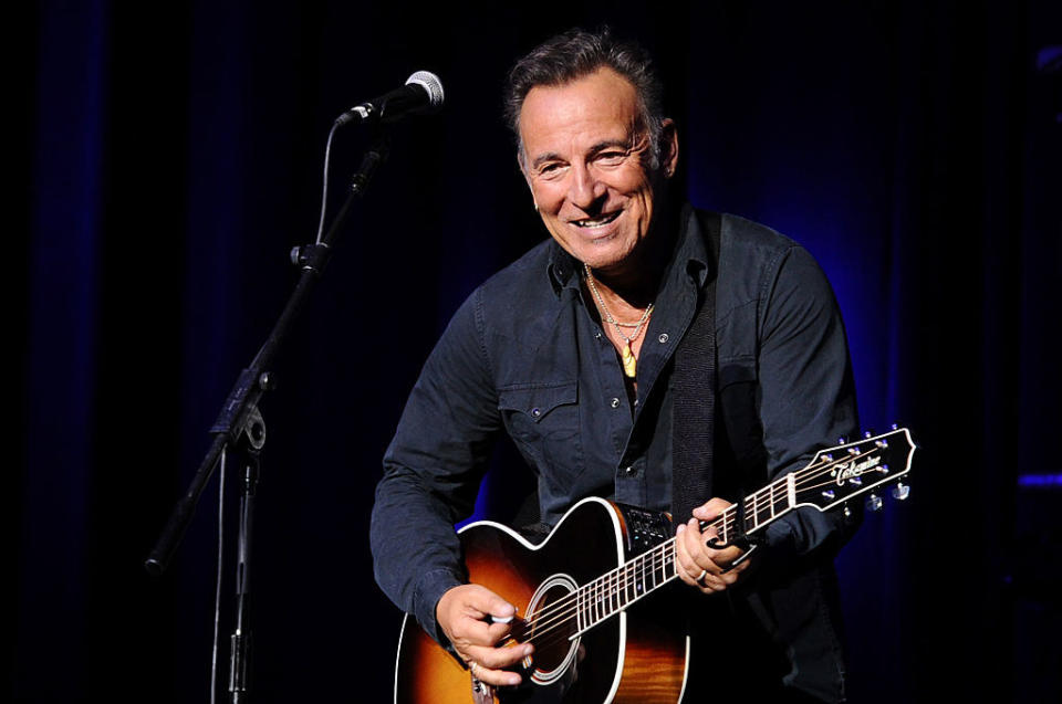 Bruce playing the guitar onstage