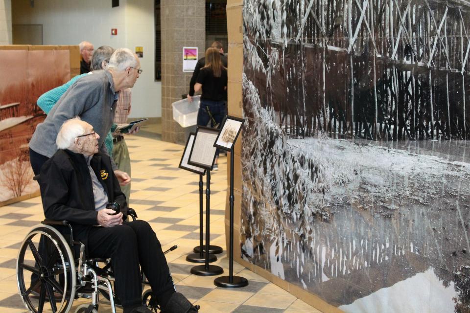 Ray Lokers, first superintendent of Hamilton Community Schools, takes in an exhibit at the "Hamilton: The Story of Us" event in March 2022.