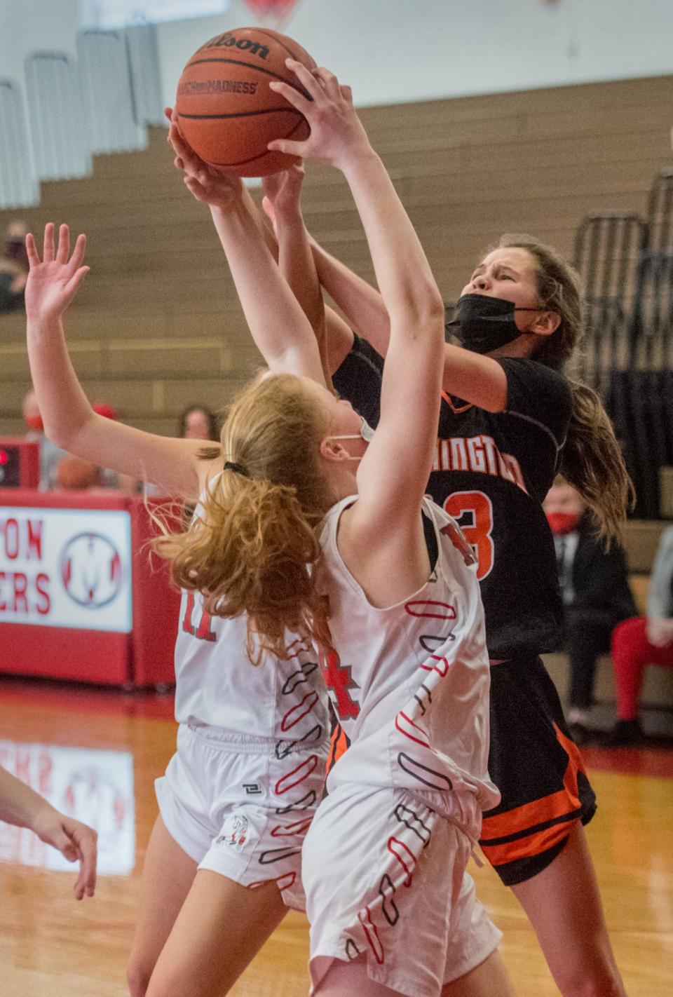 Washington’s Georgia Duncan, right, battles for a rebound against Morton’s Addy Engel (4) in the second half of the Mid-Illini Conference title game Saturday, March 13, 2021 in Morton.
