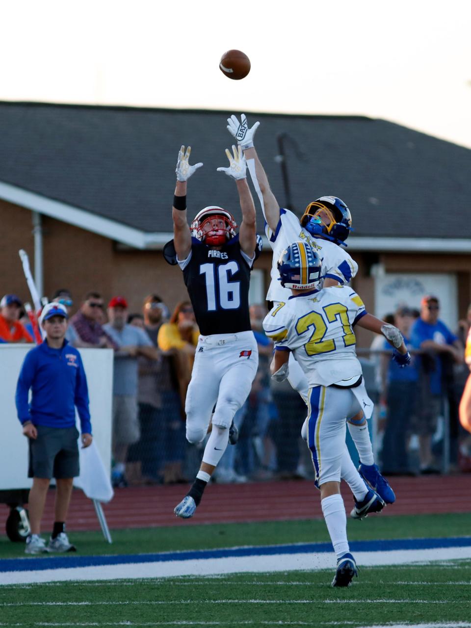 Garaway's Jenson Garber, left, and West Muskingum's Conner Hill go up for the ball during the second quarter of the Pirates' 28-0 win on Friday night in Sugarcreek.