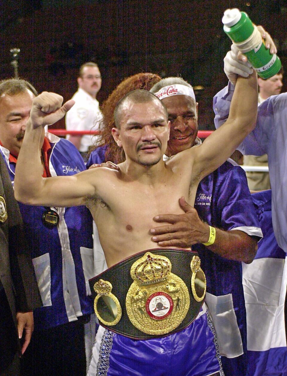 FILE - In this March 3, 2001 file photo, Nicaragua's Rosendo Alvarez celebrates his 12 round split decision over Colombia's Beibis Mendoza in their light flyweight championship fight in Las Vegas. With nearly all the world's sport shut down by the coronavirus pandemic, Nicaragua is hosting an event Saturday, April 25, 2020, with a full card of boxing matches before a live audience, organized by Alvarez, who — like the Central American nation's government — waved aside the threat of COVID-19. (AP Photo/Laura Rauch, File)