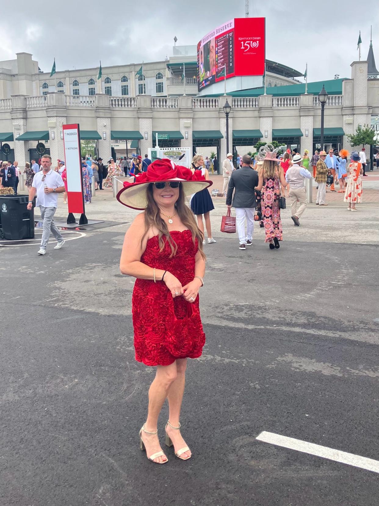 Denise Bautista, of New Smyrna Beach, Florida, wore dress and purse made of fabric roses and a necklace featuring the Kentucky Derby symbol as she stood in the Woodford Reserve Paddock Plaza at Churchill Downs in Louisville, Kentucky, on Saturday, May 4, 2024.