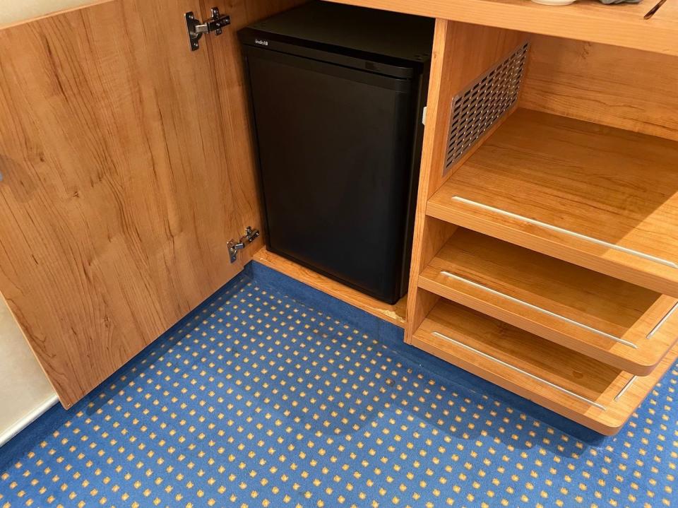 An image of the minifridge inside the cabinet.