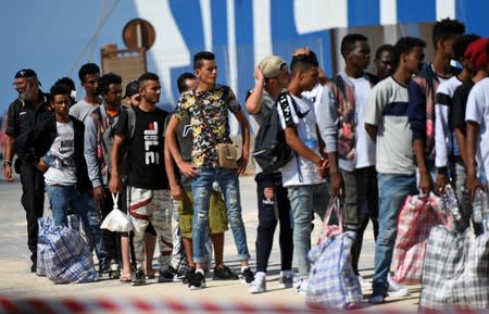 Migrants embark a ferry to the mainland, in Lampedusa