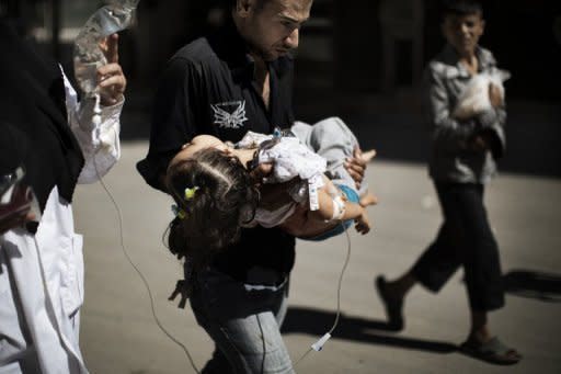 A Syrian man carries his wounded daughter outside a hospital in the northern city of Aleppo on September 18. Syrian rebels seized a crossing on the Turkish border Wednesday even as they quit a swathe of south Damascus that activists said had been reduced to a disaster area by weeks of heavy fighting