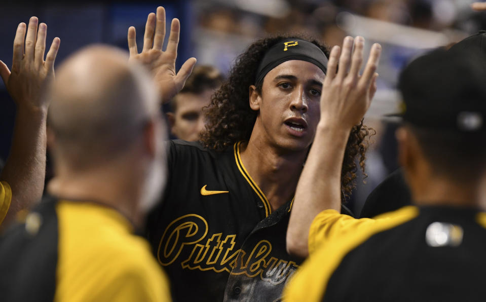 Pittsburgh Pirates' Cole Tucker, center, celebrates scoring a run against the Miami Marlins with teammates in the second inning of a baseball game, Sunday, Sept. 19, 2021, in Miami. (AP Photo/Jim Rassol)