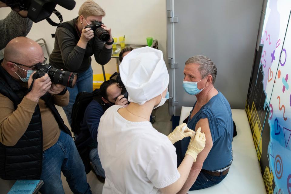 A medical worker administers the Sputnik V vaccine in MoscowAssociated Press