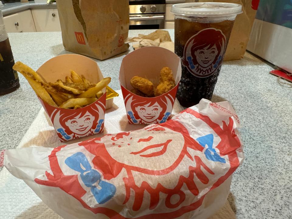 wendy's meal with fries, nuggets, a drink, and a burger